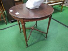 Circular mahogany table on tapered legs to casters, diameter 76cms. Estimate £10-20.