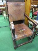 Heavy oak open armchair with leather back & seat, a/f. Estimate £50-80.