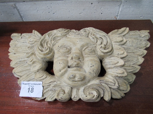 Carved wooden wall plaque of a putto. Estimate £30-50.