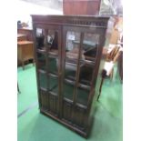 1930's style oak bookcase with glazed doors & linen fold panels, 79cms x 35cms x 136cms. Estimate £