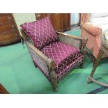 Victorian Bergère armchair with maroon coloured cushions. Estimate £30-50.