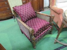 Victorian Bergère armchair with maroon coloured cushions. Estimate £30-50.