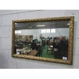Gilt foliage framed wall mirror, 118cms x 78cms. Estimate £30-50.