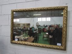 Gilt foliage framed wall mirror, 118cms x 78cms. Estimate £30-50.