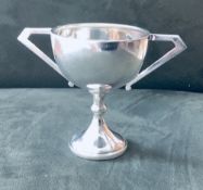 Small silver trophy, 3inch tall, unmarked. Art Deco stylized & weighing 55gms. Estimate £20-30.