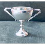 Small silver trophy, 3inch tall, unmarked. Art Deco stylized & weighing 55gms. Estimate £20-30.