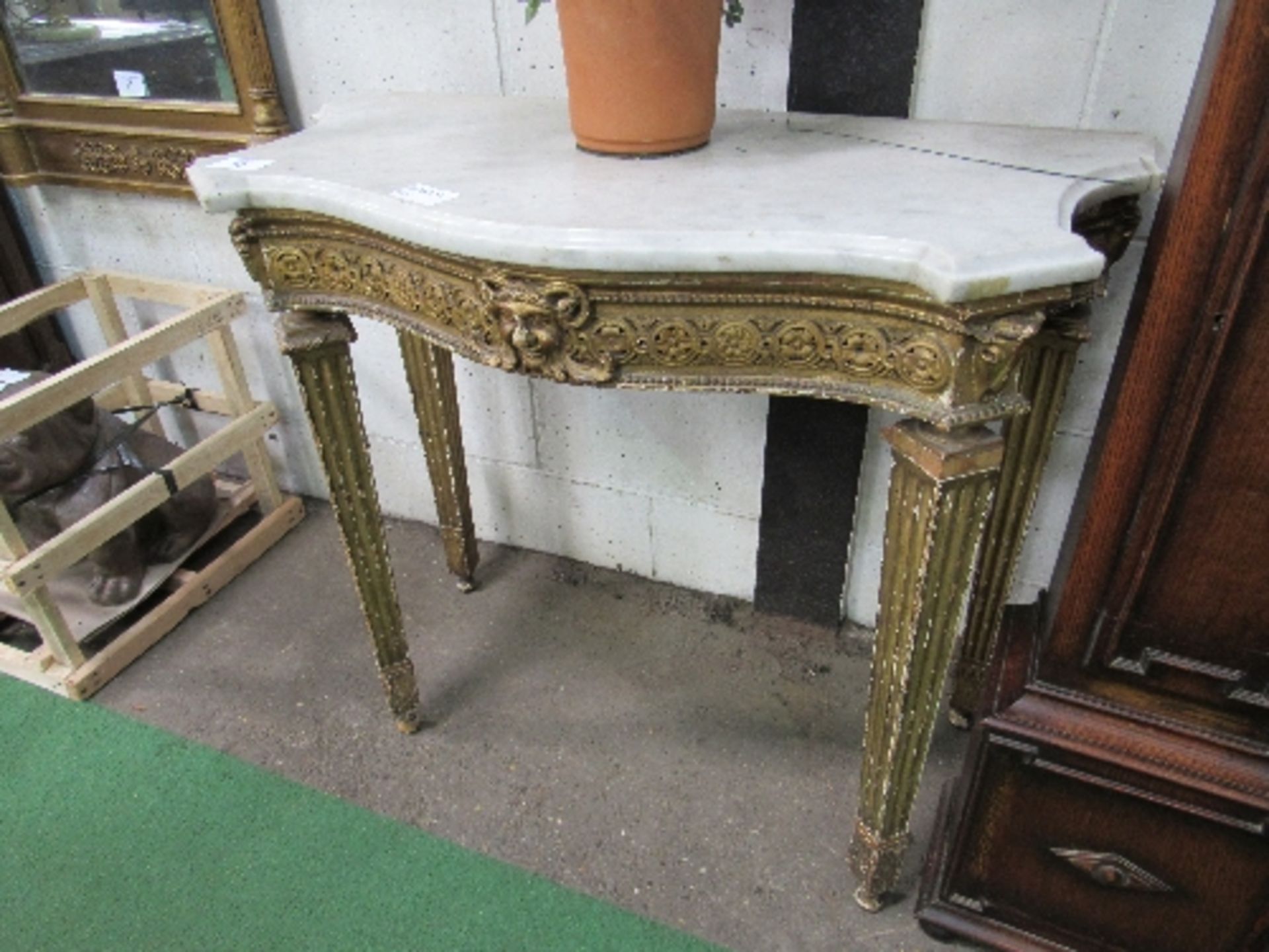 Marble serpentine top side table with ornate carved frieze to tapered gilded legs, 103cms x 51cms