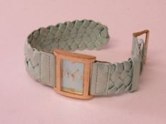 Lady's wrist watch with blue strap. Estimate £10-20.