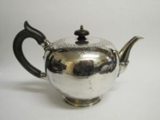 Silver teapot by Garrards of London with a wooden handle & knob, engraved with crest of rampant lion