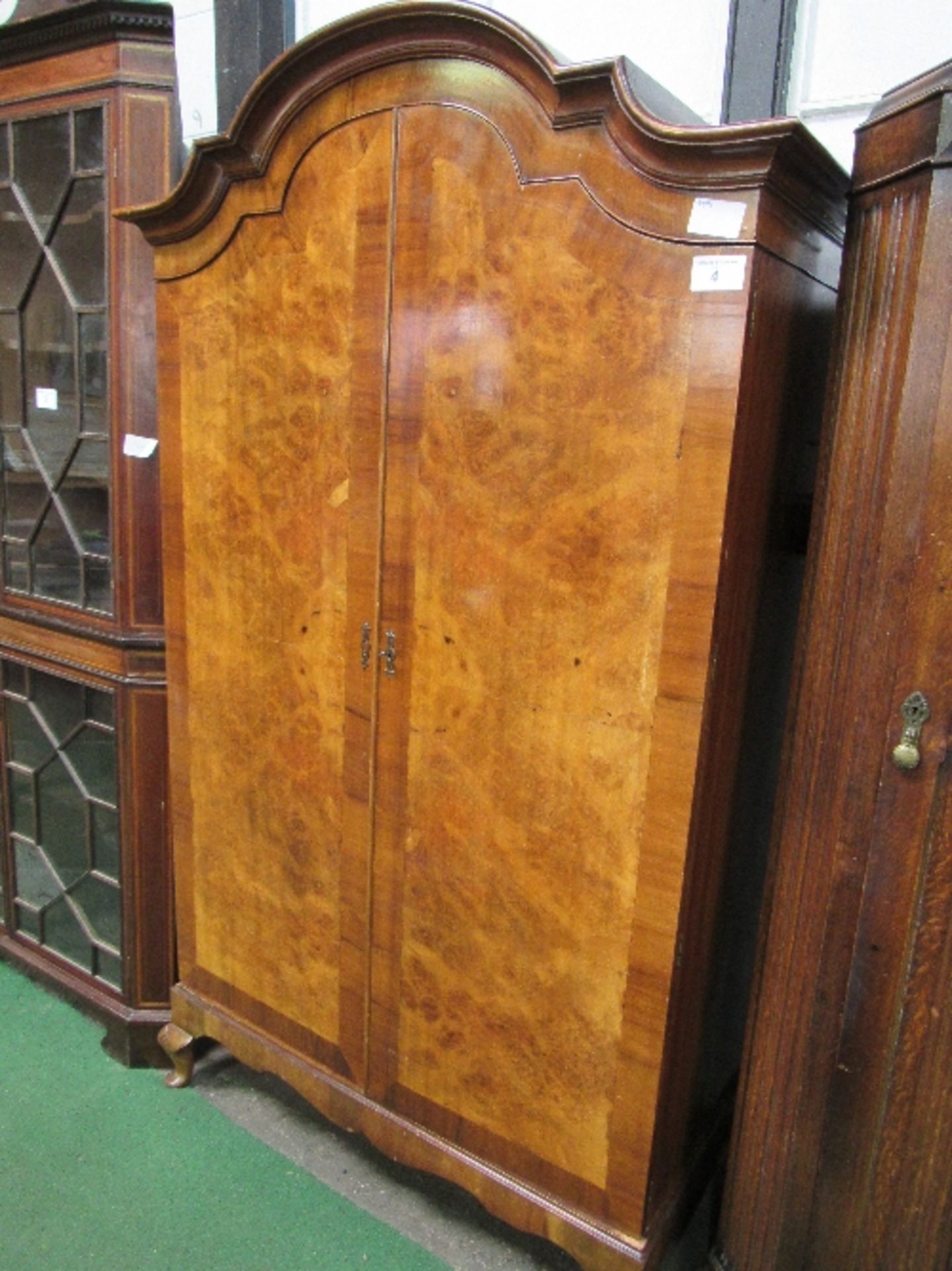 Burr walnut double door wardrobe with a break-arch top, 116cms x 48cms x 200cms. Estimate £30-40.