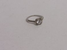 18ct (stamped) white gold ring with clear centre stone, size T 1/2, weight 3.2gms. Estimate £20-30.