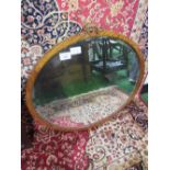 Antique walnut oval famed wall mirror, 82cms height x 89cms wide. Estimate £20-30.