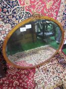 Antique walnut oval famed wall mirror, 82cms height x 89cms wide. Estimate £20-30.