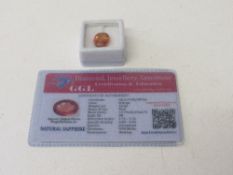 Oval cut natural orange sapphire, 10.62ct, with certificate. Estimate £50-70.