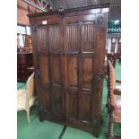 Dark oak double wardrobe with carved panel doors, 107cms x 56cms x 180cms. Estimate £60-80.