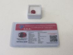 Oval cut natural red ruby, 9.43ct, with certificate. Estimate £50-70.