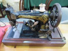 Singer electric sewing machine in wooden case, P650709. Estimate £20-30.