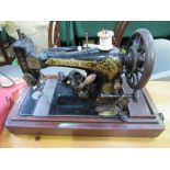 Singer electric sewing machine in wooden case, P650709. Estimate £20-30.