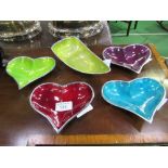 4 coloured heart-shaped enamel dishes & another dish by Azeti. Estimate £20-40.