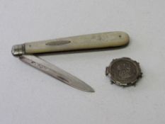 Edward VII silver fruit knife, 1902 & a George V silver sixpence in a silver mount. Estimate £20-