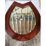 A horse-shoe shaped wall mirror with wooden frame and bevel edge glass