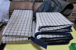 Two blue/white checked waterproof knee rugs