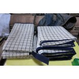 Two blue/white checked waterproof knee rugs