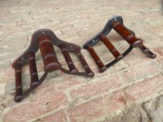 Two mahogany and metal harness pad racks by Musgrave, Belfast