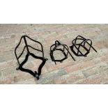 Two black painted metal bridle racks and another harness bracket