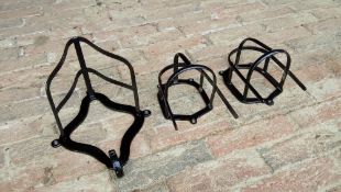 Two black painted metal bridle racks and another harness bracket