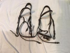 Two brown leather Cob size riding bridles