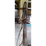 Two full size brown leather snaffle bridles with leather reins