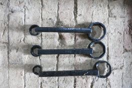 Three black metal carriage spanners