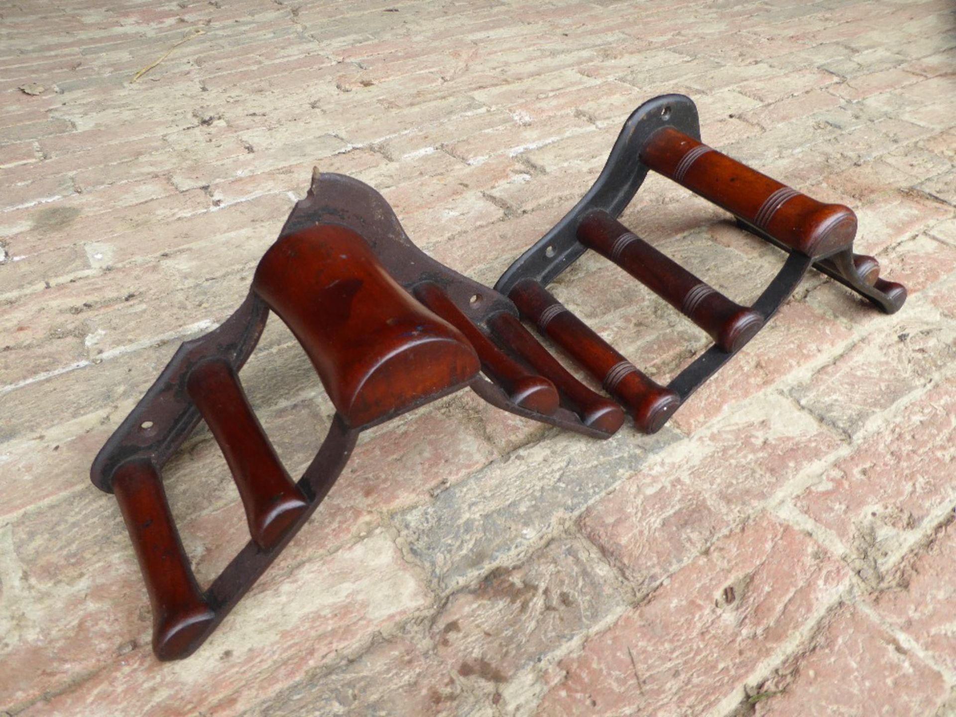Two mahogany and metal racks (one pad/one bridle) by Musgrave, Belfast (pad rack damaged)