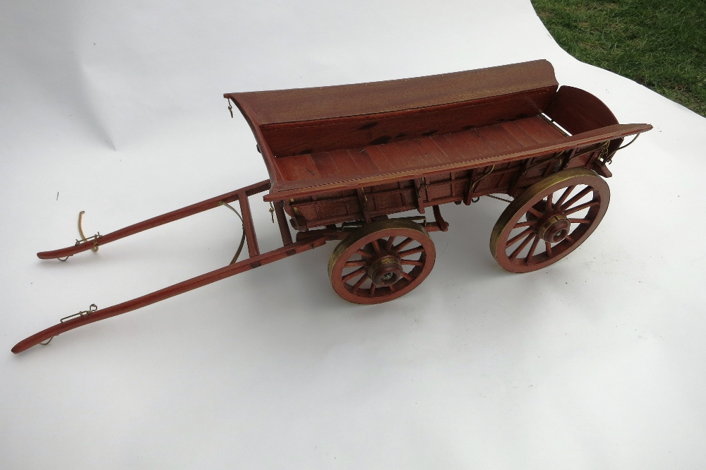 Wooden model of a four wheel farm wagon with brass fittings. Length 32ins