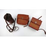 Tan leather sandwich case, a tan leather saddle bag and a brown leather flask holder (empty)