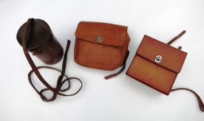 Tan leather sandwich case, a tan leather saddle bag and a brown leather flask holder (empty)