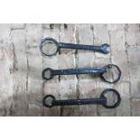 Three black metal carriage spanners