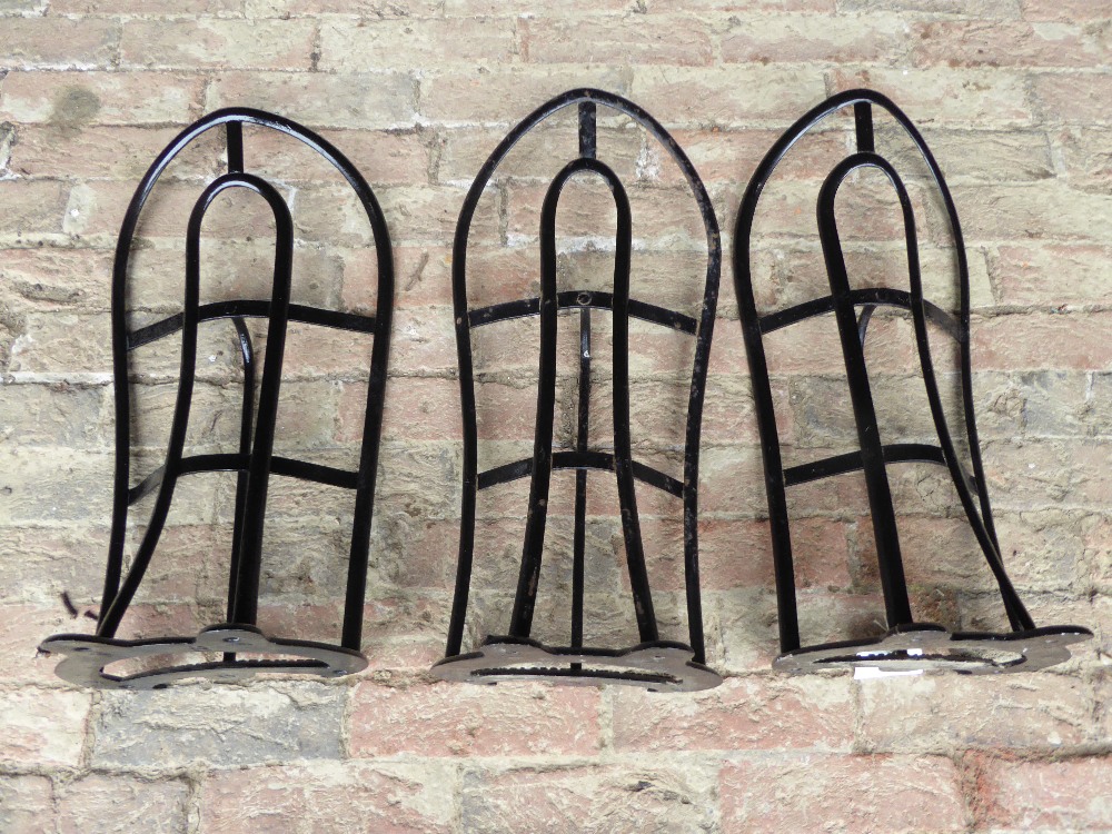 Three black painted metal saddle racks by Cottam & Willmore, London