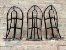 Three black painted metal saddle racks by Cottam & Willmore, London