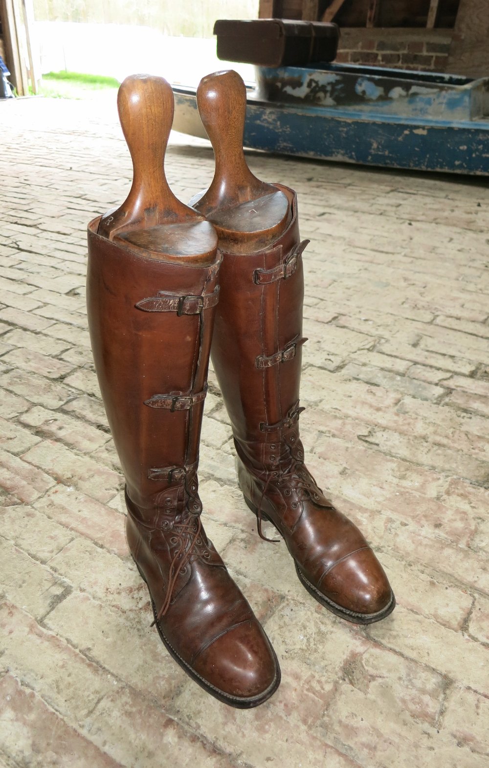 Pair of fine brown leather military long boots with laces and buckles to the front, complete with