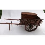 Wooden model of a two wheel farm tip cart with shaft stands and brass fittings. Length 24ins