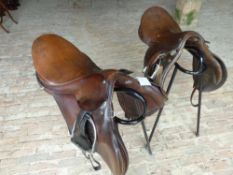 Brown leather 18ins GP saddle by Martin & Martin of Kensington with leathers and irons and a 17ins