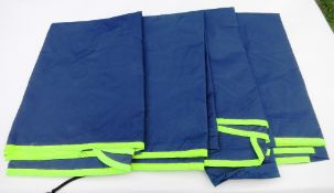 Four unused navy blue waterproof quarter sheets with fluorescent yellow piping