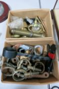 Two boxes containing a quantity of miscellaneous metalware including brass terrets; a pair of brass