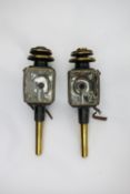 A pair of black/brass square fronted carriage lamps with candle stems, pagoda tops and small leather