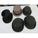 Three bowler hats, a grey top hat and a black silk top hat