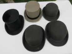 Three bowler hats, a grey top hat and a black silk top hat