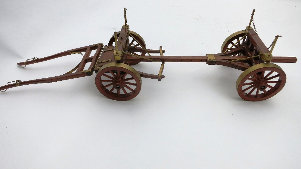 Wooden model of a four wheel timber wagon with brass decoration. Length approx. 35ins