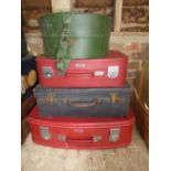 Three various sized suitcases, green hat box and a pair of 1950's Puck Master speed skates, size 8